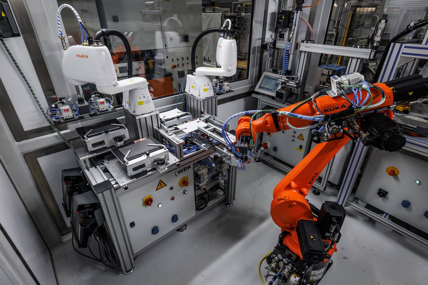 KUKA robotic arms perform automated quality inspection in a modern factory setting, highlighting advanced production processes