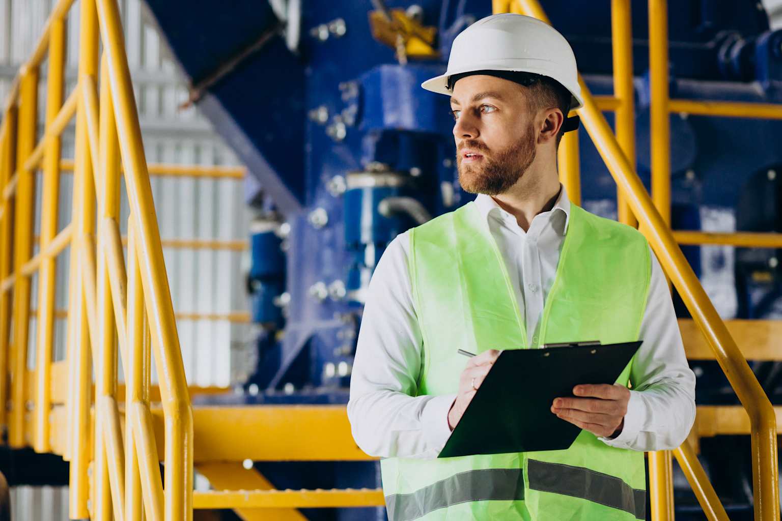 An engineer or inspector performing quality control checks in an industrial manufacturing facility