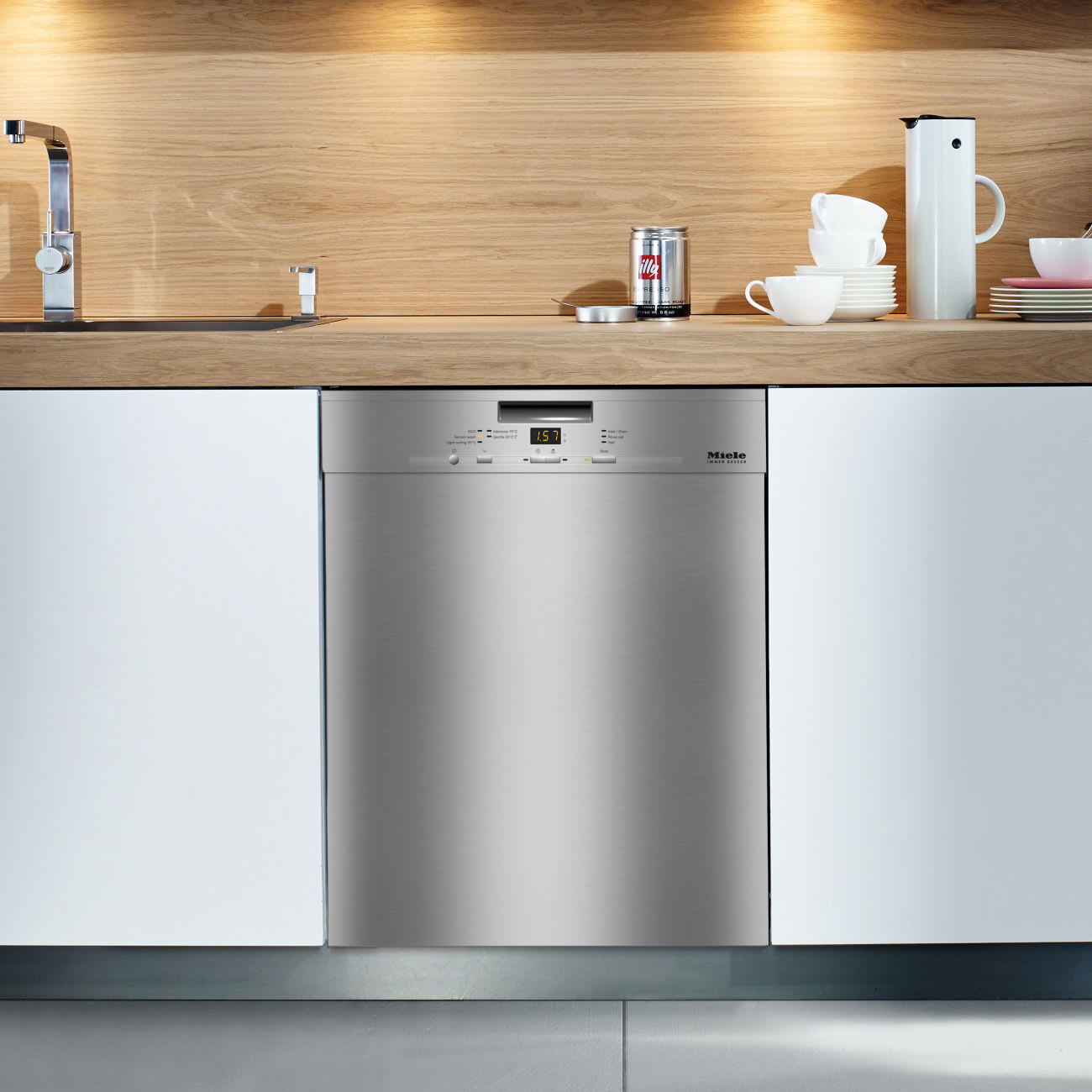 A Miele stainless steel built-in dishwasher integrated into a contemporary kitchen design