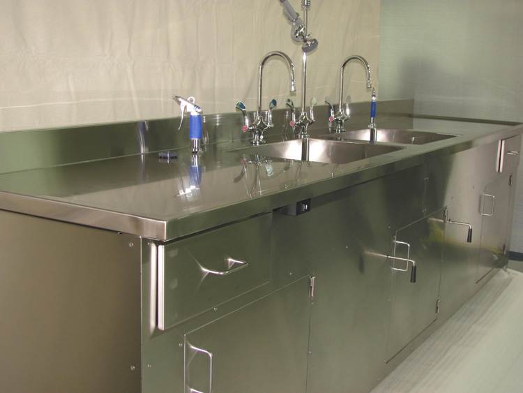 Custom stainless steel commercial kitchen sink with multiple compartments and integrated cleaning features