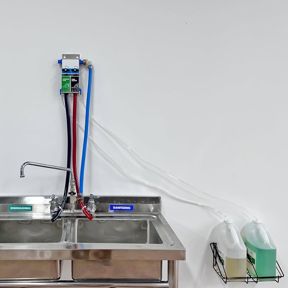 A commercial two-compartment sink with a wall-mounted chemical dispenser system for dishwashing and sanitizing